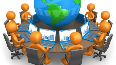 Royalty-free 3d computer generated business clipart picture of a group of orange people working on laptops at a round table with a globe in the center, on a white background with shading.